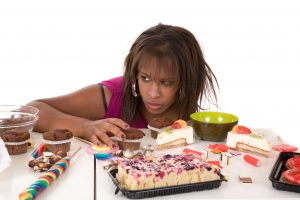 black lady eating sugary foods